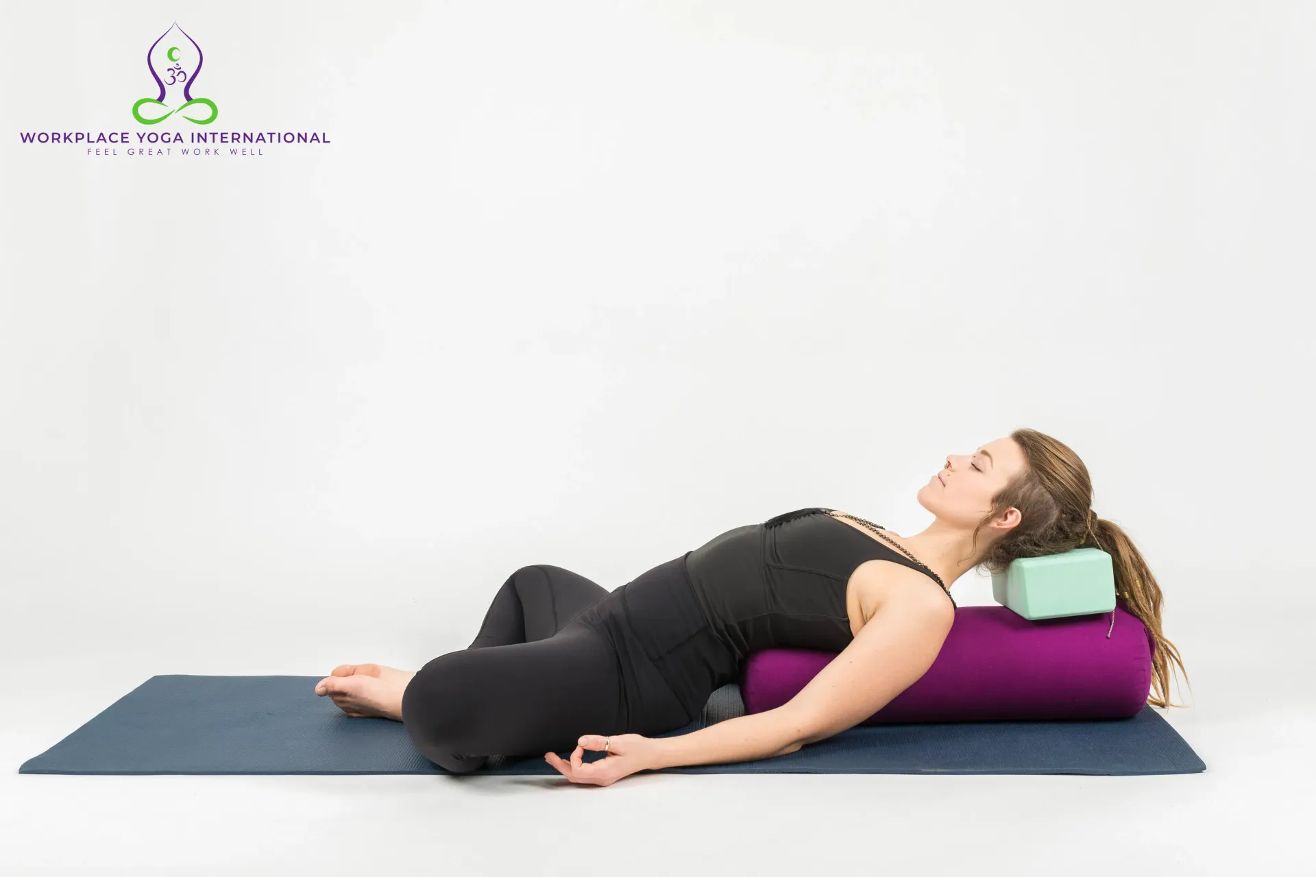 Supported restorative yoga posture on a mat